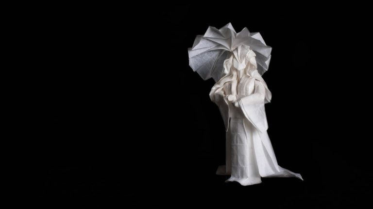 Origami person walking in the rain
